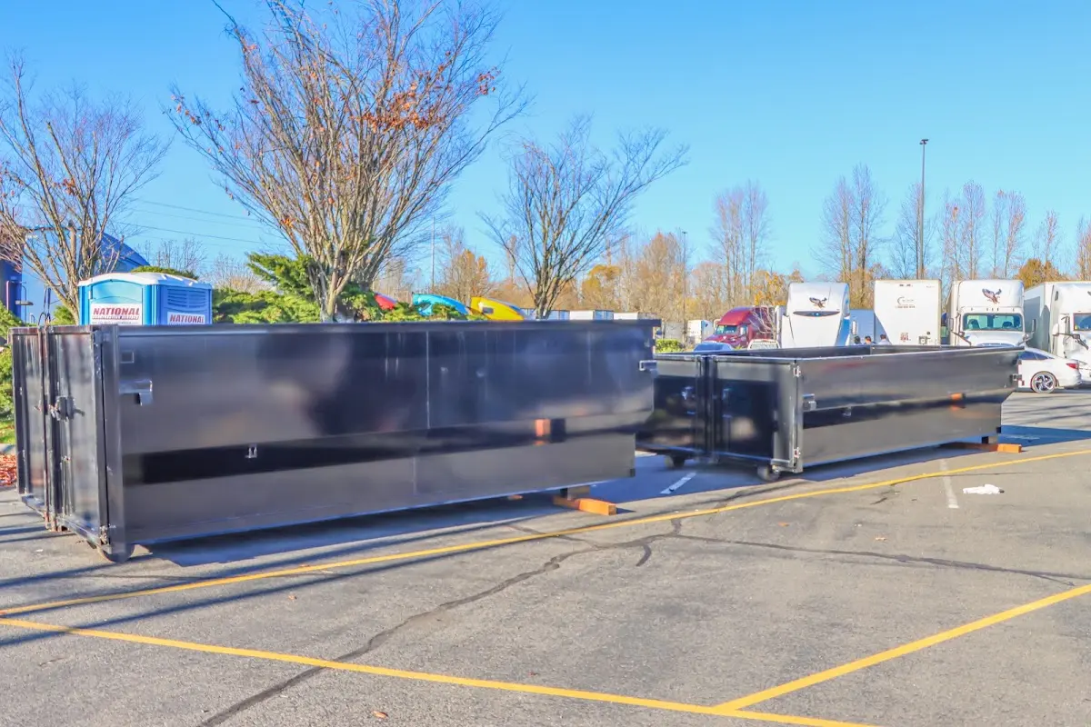 Professional dumpster rental service with roll-off container on residential driveway in Perkiomen